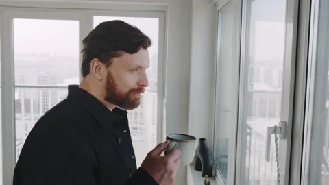 Redhead man with beard looking at window. 스톡 동영상 174717553