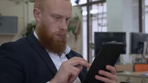 Redhead manager use gadjet in office Stock Footage 83323971