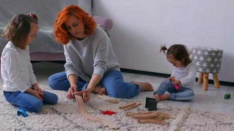 A redhead mother with the two daughters playing in the house 스톡 동영상 129339938