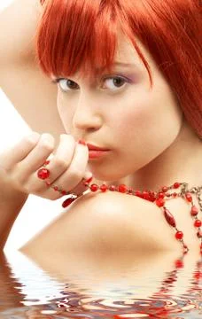 Redhead with red beads looking over shoulder in water Stock Illustration