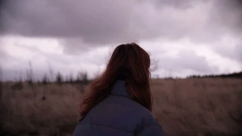 Redhead walking trough the meadow Stock Footage