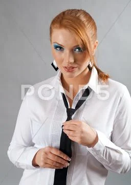 Redheaded girl in white shirt and tie Stock Photos
