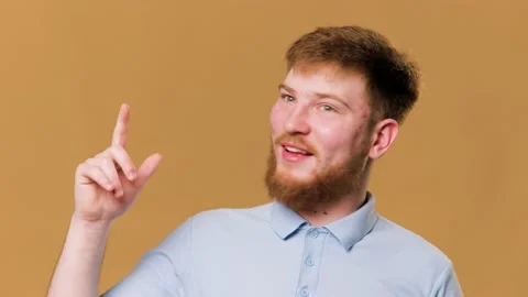 A redheaded guy standing in the studio with a Stock Footage 234691096