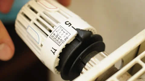 Reduce heating costs - turn down the heating Stock Footage 22543985