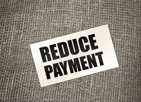 Reduce payment text on card on burlap canvas. business concept Stock Photos