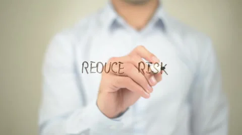 Reduce Risk,  Man writing on transparent screen Video stock 62983142