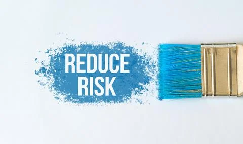 Reduce Risk text on blue paint with brush on white background Stock Photos