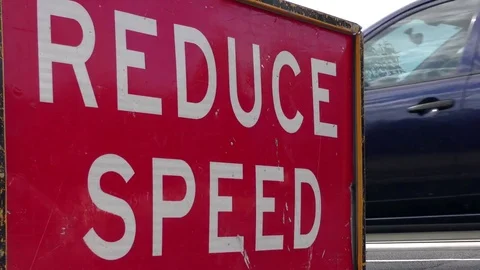 Reduce Speed sign warning for traffic on street Stock Footage 71750518