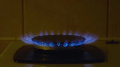 Reducing the flame on the gas stove 4K Stock Footage 218373976