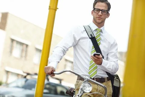 Reducing his carbon footprint. A young businessman standing with his bicycle Stock Photos