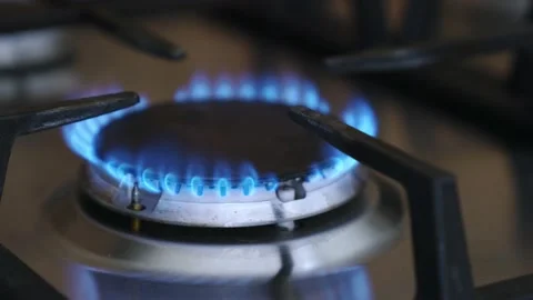 Reducing the intensity of the natural gas flame on the kitchen gas stove. Stock Footage 220136334