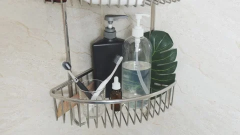 Reducing visual clutter. Bathroom toiletries organized in shower caddy, showing Video stock 338390869