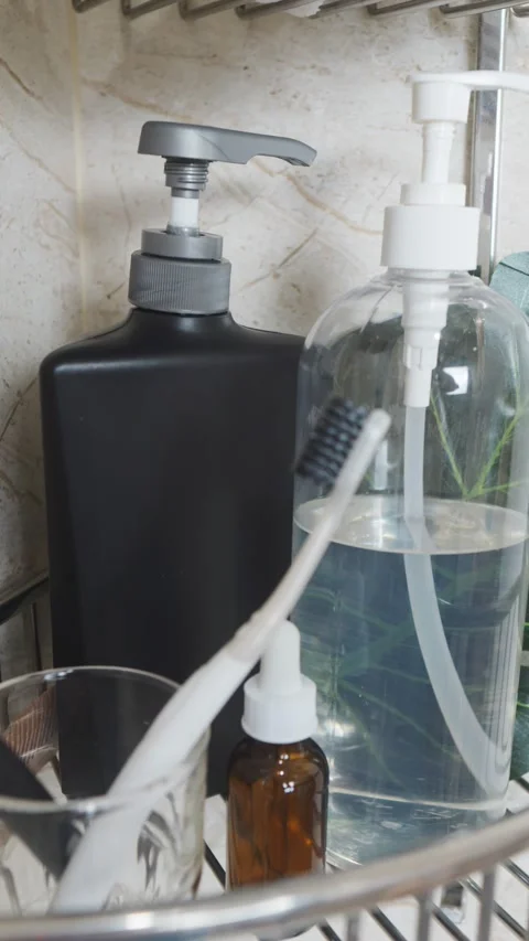 Reducing visual clutter. Black pump bottle and toothbrush on a shelf, showing Video stock 338393243