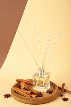 Reed diffuser, anise star and cinnamon on brown background. Vertical photo Stock Photos