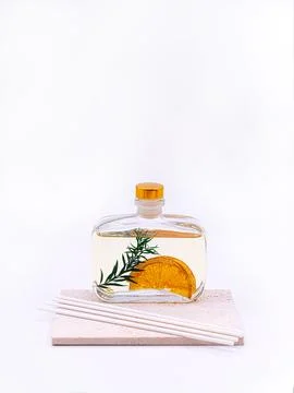 Reed diffuser with cinnamon and orange on white background Stock Photos