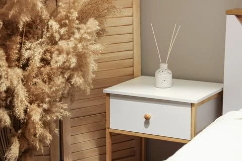 Reed diffuser on nightstand in bedroom at night Stock Photos