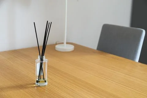 Reed diffuser on wooden table. Scent, calmness, and home fragrance in peacefu Stock Photos