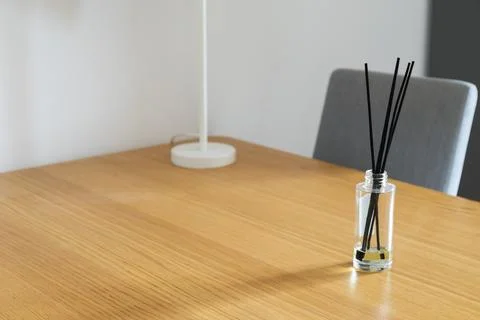 Reed diffuser on wooden table. Scent, calmness, and home fragrance in peacefu Stock Photos