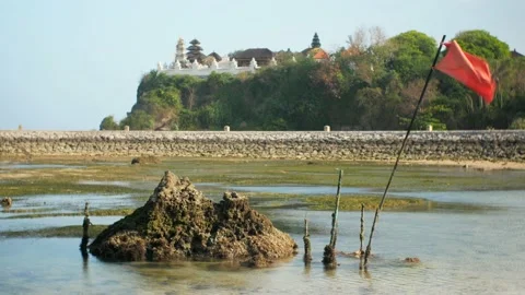 Reef with flag in front of temple on rock Stock Footage 166079350