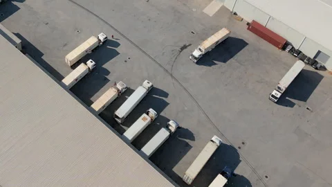 Reefer Trailers Queued at Logistics Dock, Drone Flyover Stock Footage 338027695