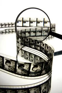 Reel of film and magnifying glass Stock Photos