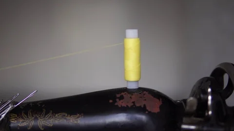 Reel with yellow threads spinning on an old sewing machine. Stock Footage 112218286