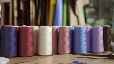 Reels with colored threads on the table in the studio Stock Footage 124282341