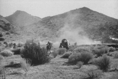 Reenactment of outlaws attacking covered wagon, 1930s Stock Footage 90727836