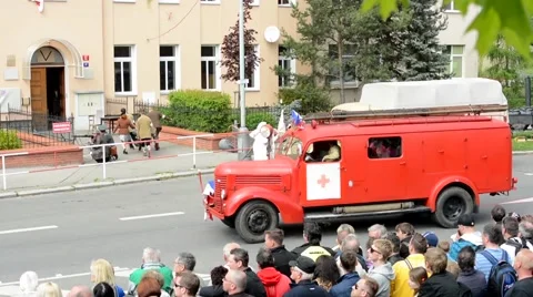 Reenactment performance battle of World War II on the street - vintage ambulance Stock Footage 49904891