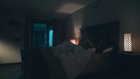 Reenactment: Static shot of a scared woman suddenly wakes up from her deep sleep Stock Footage 235330945