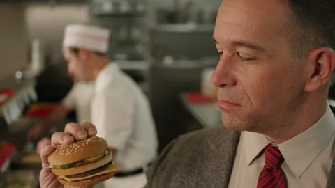 Reenactment: Tilt-up shot of an executive picking-up a Big Mac, California, USA, Vidéo 235325816