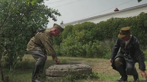 Reenactors helping female partisan out of sewer 스톡 동영상 339204599