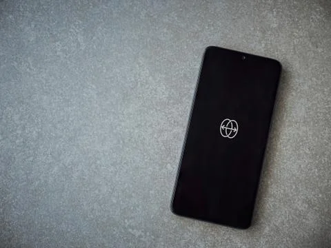 Reface app launch screen with logo on the display of a black mobile smartphon Stock Photos