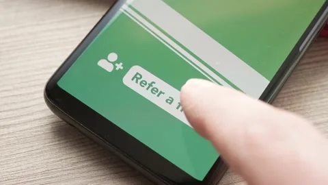 Refer a Friend Button on a Smartphone Screen Closeup Stock Footage 227027621