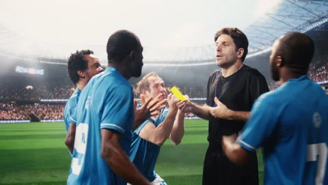 Referee blowing whistle and showing yellow card toward protesting player Stock Footage 337994936