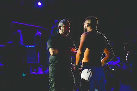 Referee is checking fighter before enters in ring, cage at MMA match Stock Photos