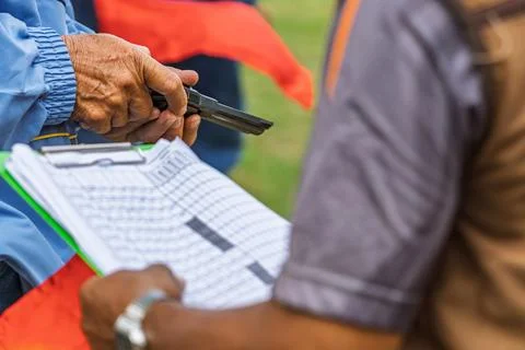 Referee checking starting pistol revolver for sports competition. .Sports o.. Stock Photos