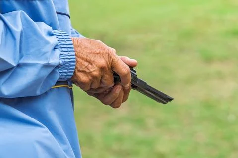Referee checking starting pistol revolver for sports competition. .Sports o.. Stock Photos