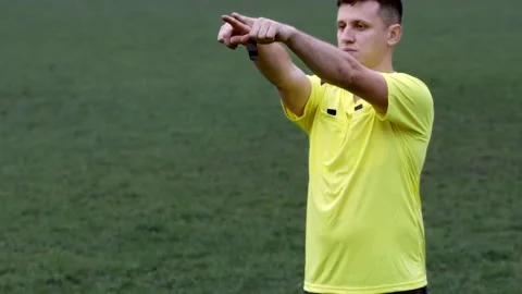 Referee goes watching VAR or violation of the rules and shows a penalty, yellow  Stock Footage 145016056