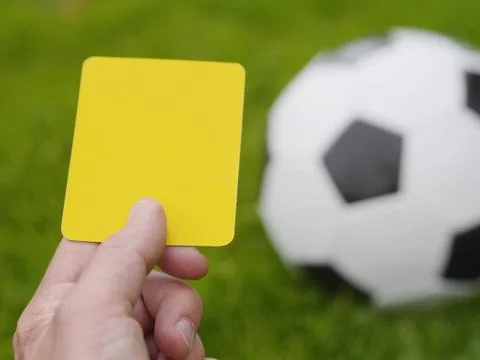 Referee hand with yellow card Foto stock