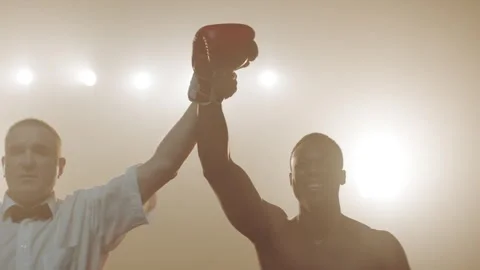 Referee holding the hand of the winner in a boxing match Stock Footage 283294218