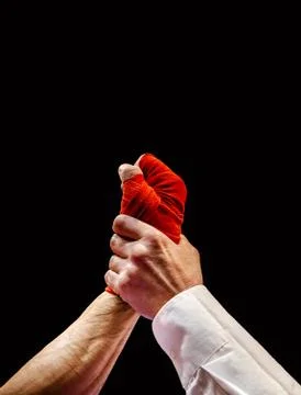 Referee raise hand of winning boxer Stock Photos