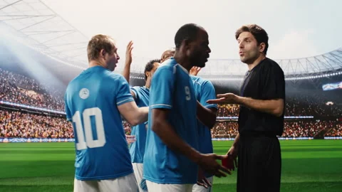 Referee raising red card toward soccer player protesting dismissal Stock Footage 337995189