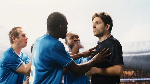 Referee showing second yellow card and eliminating blue team player Stock Photos