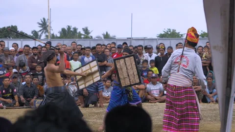 Referee stops fight and dances at Peresean Stick Fighting Festival at Video stock 131087932