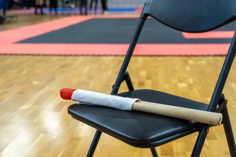 The referee's red and white flags are waiting for the referee on the chairs. Stock Photos