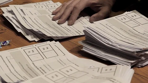 Referendum - sorting ballot papers in a referendum close up view Stock Footage 97403727
