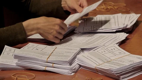 Referendum - sorting ballot papers in Yes and No -- mostly Yes  Stock Footage 97403943