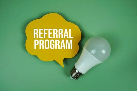 Referral Program text with light bulb on green background 写真素材