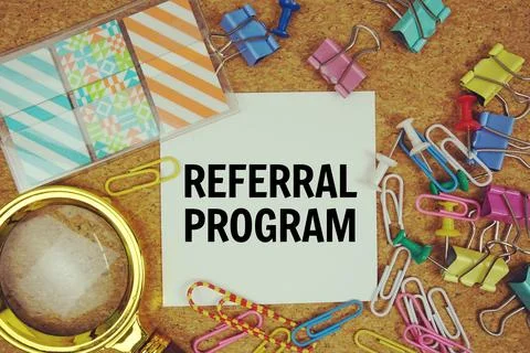 Referral Program text on paper card with magnifying glass and stationery on.. Stock Photos
